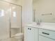 Modern bathroom featuring a glass-enclosed shower and sleek vanity with white countertop at 1146 Cottonsprings Dr, Wendell, NC 27591