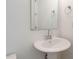 Bathroom featuring a pedestal sink with chrome faucet, mirror and towel holders at 1146 Cottonsprings Dr, Wendell, NC 27591