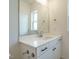 Modern bathroom features a sleek vanity with undermount sink and a large mirror at 1146 Cottonsprings Dr, Wendell, NC 27591