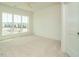 Bright bedroom features plush carpeting, white walls, and large window with neighborhood views at 1146 Cottonsprings Dr, Wendell, NC 27591