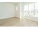 A bright bedroom featuring hardwood floors and natural light from a large window at 1146 Cottonsprings Dr, Wendell, NC 27591