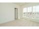 Bright bedroom features plush carpeting, white walls, and large window with community parking views at 1146 Cottonsprings Dr, Wendell, NC 27591