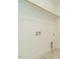 Walk-in closet featuring neutral paint, wood shelf and utility connections at 1146 Cottonsprings Dr, Wendell, NC 27591