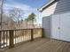 Exterior deck featuring wood railings, wooden floor and views of the surrounding wooded area at 1146 Cottonsprings Dr, Wendell, NC 27591
