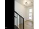 Bright entryway features hardwood floors, white walls, and modern light fixture at 1146 Cottonsprings Dr, Wendell, NC 27591