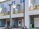 Exterior view of townhomes with private garages and wooden balconies at 1146 Cottonsprings Dr, Wendell, NC 27591