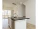 Modern kitchen with white cabinets, black countertops, stainless steel appliances, and large island at 1146 Cottonsprings Dr, Wendell, NC 27591