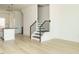 Open living space featuring hardwood floors, a modern staircase, and a glimpse of the kitchen at 1146 Cottonsprings Dr, Wendell, NC 27591