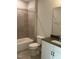 Bright bathroom featuring a shower-tub combo, tiled walls, and white vanity at 3010 Freewinds Way # 43, Cary, NC 27519
