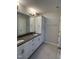 Bright bathroom with double vanity, gray countertops, and white cabinets for storage at 3010 Freewinds Way # 43, Cary, NC 27519