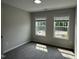 Neutral bedroom offering comfortable carpet, two bright windows, and natural light at 3010 Freewinds Way # 43, Cary, NC 27519