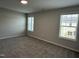 Spacious bedroom featuring carpet, two large windows, and neutral wall color at 3010 Freewinds Way # 43, Cary, NC 27519
