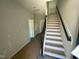 Entryway with stairs, light gray walls, and black trim, providing a welcoming first impression at 3010 Freewinds Way # 43, Cary, NC 27519