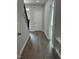 Light-filled hallway with wood-look flooring and access to multiple rooms at 3010 Freewinds Way # 43, Cary, NC 27519
