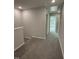 Second floor hallway with carpet, neutral paint, and access to additional bedrooms at 3010 Freewinds Way # 43, Cary, NC 27519