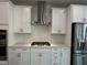 Up close kitchen view of stainless steel appliances, modern cabinets, and range hood at 3010 Freewinds Way # 43, Cary, NC 27519
