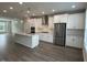 Open-concept kitchen with stainless steel appliances, center island, and ample lighting at 3010 Freewinds Way # 43, Cary, NC 27519