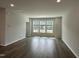 Bright living room with hardwood floors and plenty of natural light from large windows at 3010 Freewinds Way # 43, Cary, NC 27519