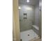 Modern walk-in shower featuring gray tiled walls, shower bench, and seamless glass door at 3010 Freewinds Way # 43, Cary, NC 27519