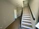 Modern staircase with dark railings leading to the upper level at 3010 Freewinds Way # 43, Cary, NC 27519