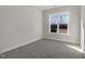 Sunlit bedroom features neutral paint, carpet flooring and a view to the outside at 153 Wilderness Trl, Smithfield, NC 27577