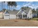 New construction home with gray siding, white trim and stone accents at 153 Wilderness Trl, Smithfield, NC 27577