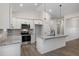 Modern kitchen with white cabinets, granite countertops, and stainless steel appliances at 154 Wilderness Trl, Smithfield, NC 27577