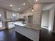 Modern kitchen with white cabinets, granite island, and dark floors at 154 Wilderness Trl, Smithfield, NC 27577