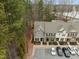 Aerial view of townhomes, parking lot, and tree-lined property at 7801 Otura Way, Raleigh, NC 27612