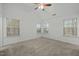 Bedroom with vaulted ceiling, carpet flooring, three windows and a ceiling fan at 7801 Otura Way, Raleigh, NC 27612