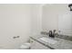 Clean, modern powder room with granite countertop, white cabinetry, and a decorative mirror, designed for convenience at 573 Highview Drive Dr, Benson, NC 27504