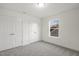 Carpeted bedroom featuring standard closet, neutral walls, and window at 573 Highview Drive Dr, Benson, NC 27504