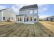 Rear view of the home showing the patio and freshly installed sod in the backyard at 573 Highview Drive Dr, Benson, NC 27504