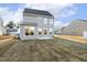Rear view of the home showing the patio and freshly installed sod in the backyard at 573 Highview Drive Dr, Benson, NC 27504