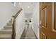 Bright foyer with staircase, paneled walls, hardwood floors, and an open doorway, providing a grand entrance at 573 Highview Drive Dr, Benson, NC 27504