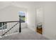 Hallway featuring views into a bathroom and a staircase, carpeted floors and neutral walls at 573 Highview Drive Dr, Benson, NC 27504