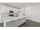 Bright kitchen features a large kitchen island, stainless steel appliances, and white cabinets at 573 Highview Drive Dr, Benson, NC 27504