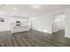 Spacious open floor plan showcasing gray floors and a modern kitchen with white cabinets and a center island at 573 Highview Drive Dr, Benson, NC 27504