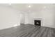 Living room featuring a fireplace and gray wood floors, ideal for a cozy atmosphere at 573 Highview Drive Dr, Benson, NC 27504