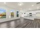 Open-concept living area featuring gray floors, large windows, and a kitchen island, perfect for modern living at 573 Highview Drive Dr, Benson, NC 27504