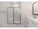 Modern bathroom with a walk-in shower and white vanity with a quartz countertop at 607 Tuscany Cir, Princeton, NC 27569