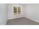 Spacious bedroom with a window and carpeted floors at 607 Tuscany Cir, Princeton, NC 27569