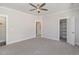 Spacious bedroom with carpet flooring, ceiling fan, and access to bathroom and closet at 607 Tuscany Cir, Princeton, NC 27569