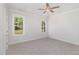 Bright bedroom with carpet flooring, ceiling fan, and large windows offering natural light at 607 Tuscany Cir, Princeton, NC 27569