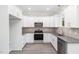 Modern kitchen with white cabinets and stainless steel appliances at 607 Tuscany Cir, Princeton, NC 27569