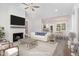 Open living room with fireplace and view into kitchen and dining area at 607 Tuscany Cir, Princeton, NC 27569