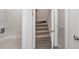 Indoor staircase with carpeted steps and wood flooring at 607 Tuscany Cir, Princeton, NC 27569