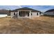 Rear exterior of house featuring siding, covered porch and small yard at 639 Sweet Potato Lane # 3, Nashville, NC 27856