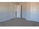 Cozy bedroom with carpet, neutral walls, white trim, and several doors at 639 Sweet Potato Lane # 3, Nashville, NC 27856