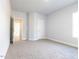 Neutral bedroom with carpet, white trim and walls and a door to the hallway at 639 Sweet Potato Lane # 3, Nashville, NC 27856